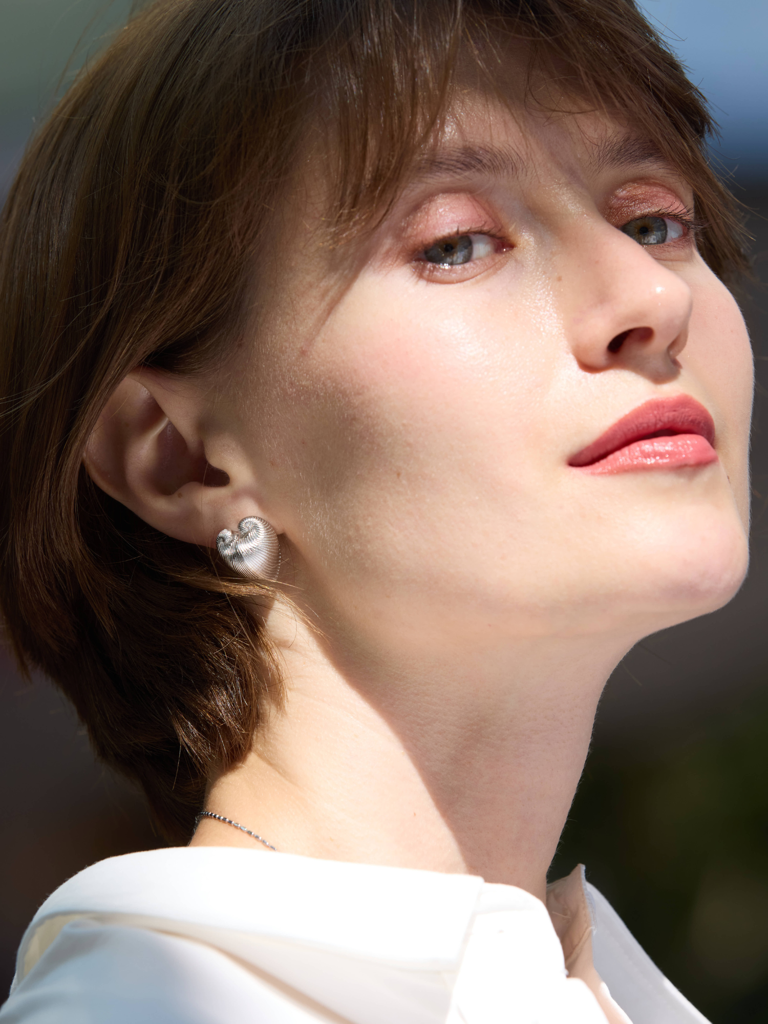 Close-up of a person wearing a diamond earring