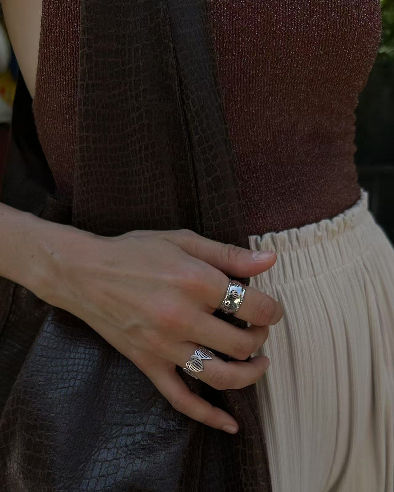 Person with celestes jewelry in heartline rings