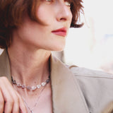 Woman wearing a necklace with a blurred background