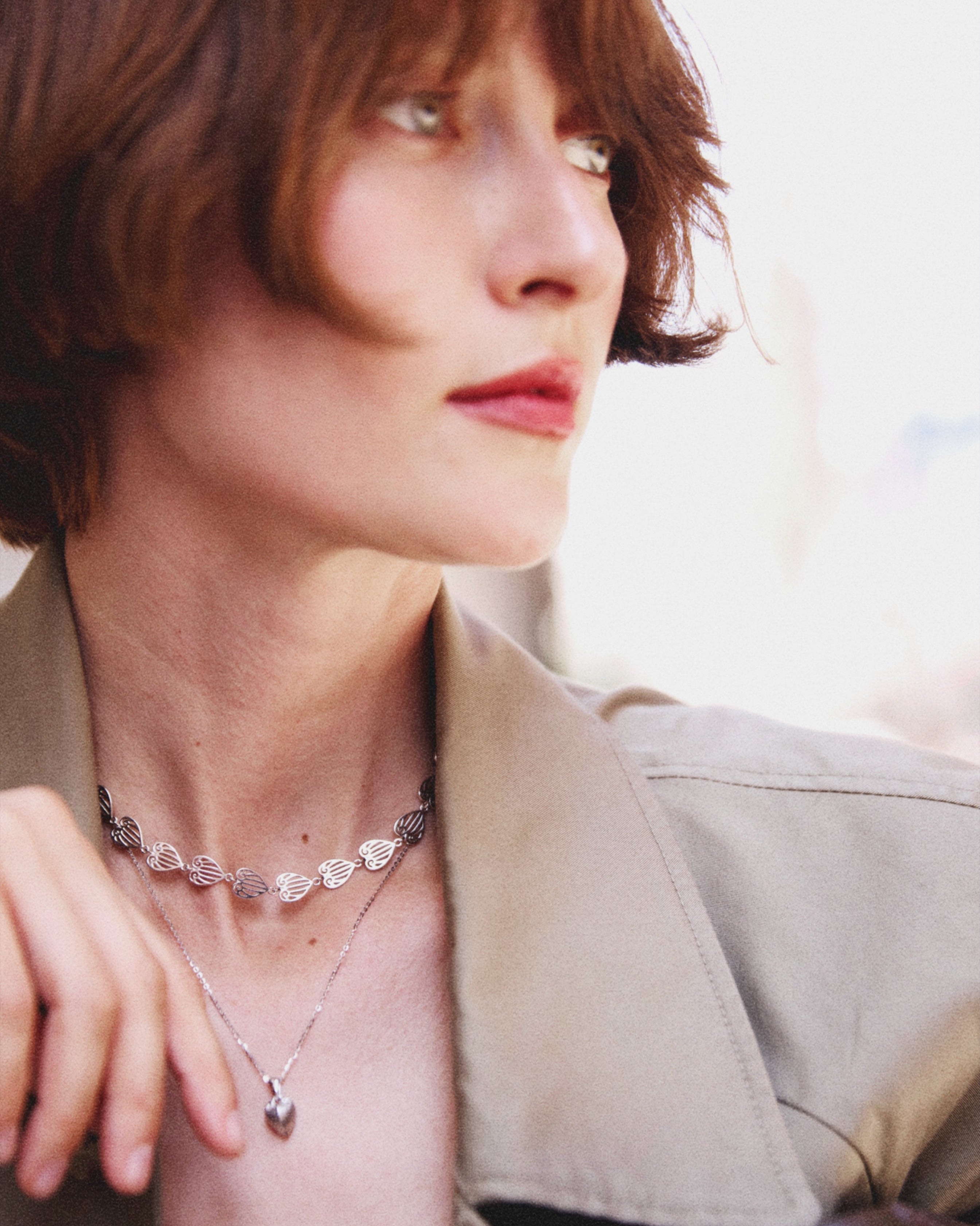 Woman wearing a necklace with a blurred background