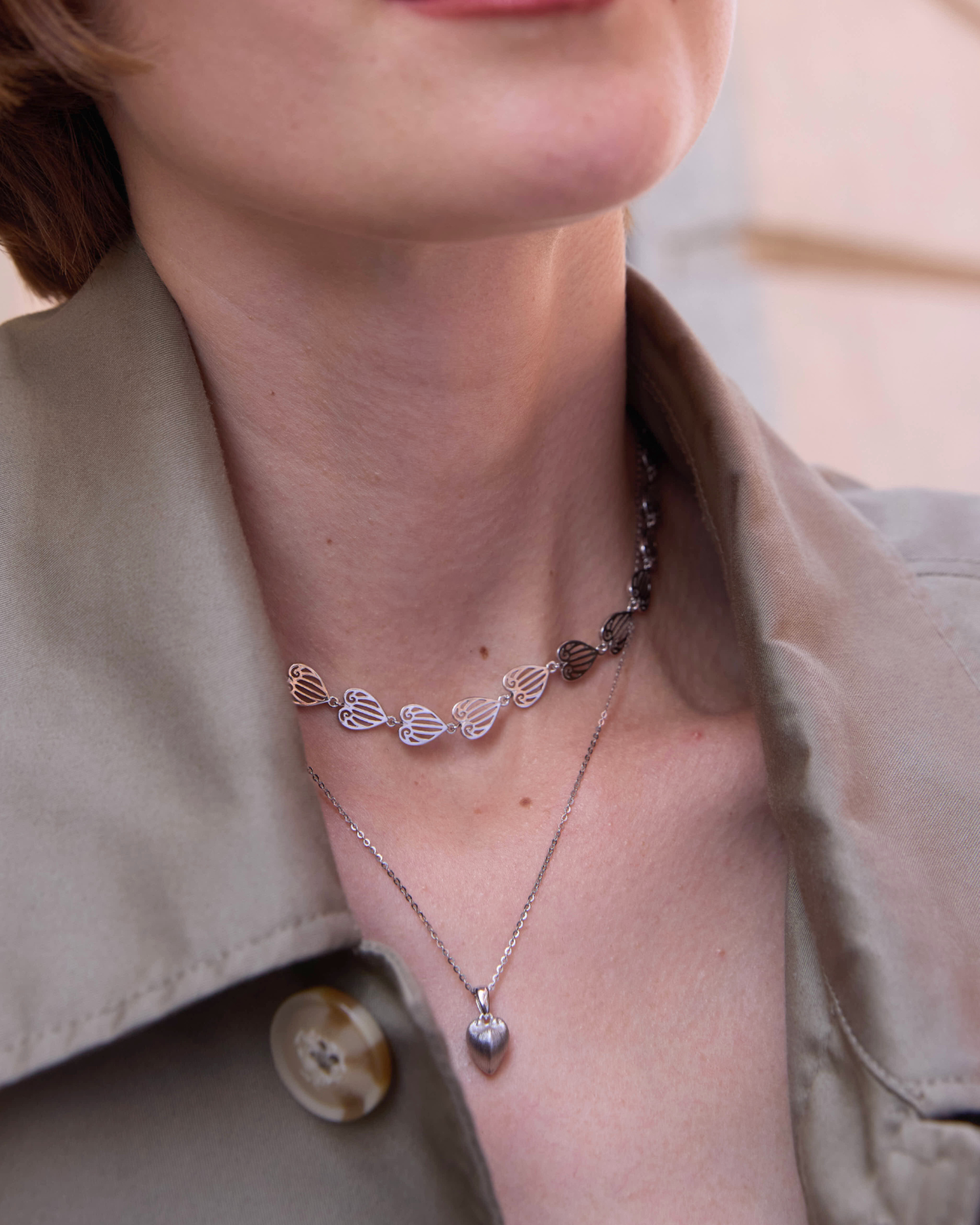 Close-up of a person wearing a necklace with 'Célestes Jewelry' branding.