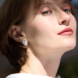 Close-up of a person wearing a diamond earring 