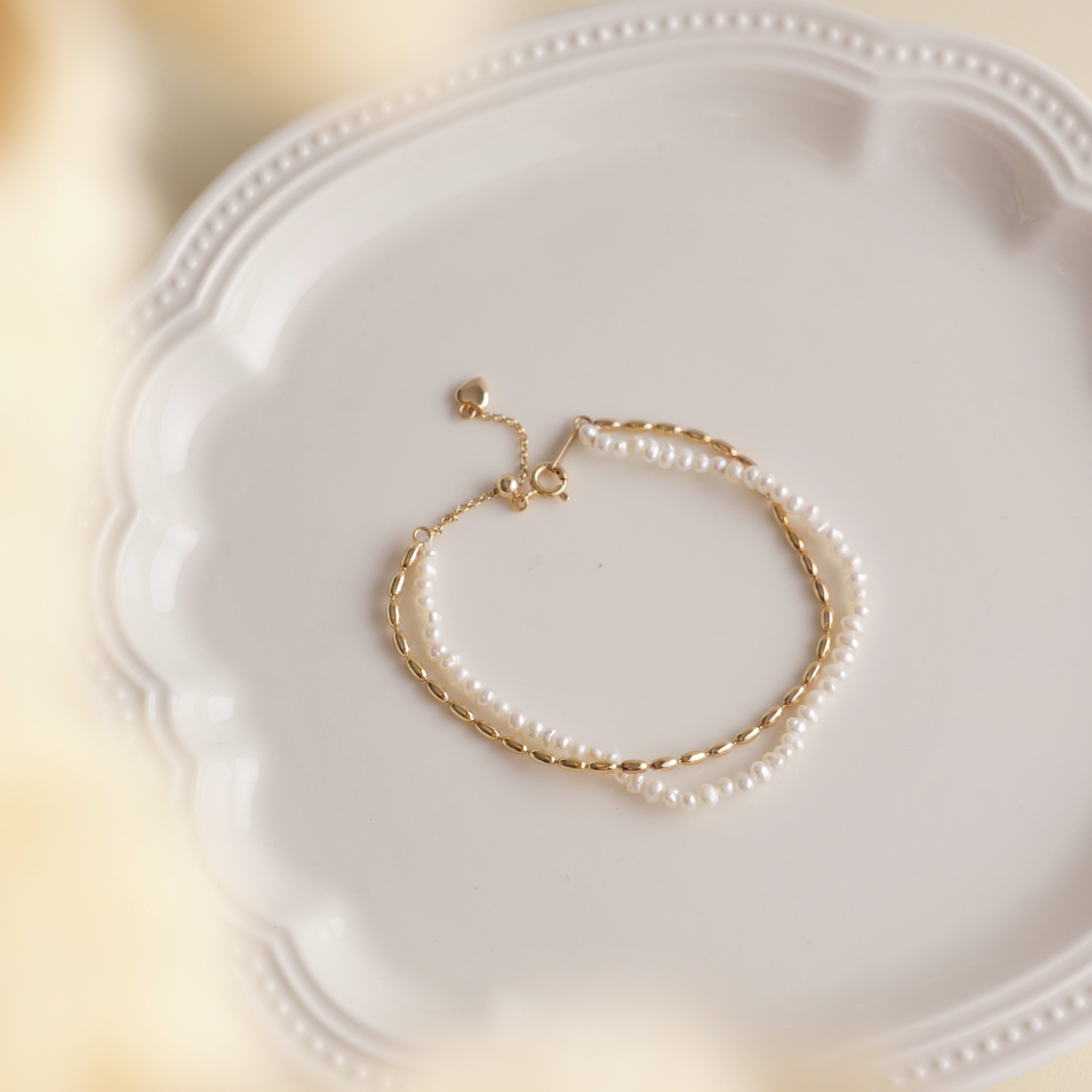 Gold and pearls are a timeless combination that never fails to impress. This delicate pearl bracelet, paired with a matching necklace, makes the perfect accessory duo to elevate any outfit. I’ve included styling references in the listing photos to give you inspiration on how to wear it.
- Pearl Size: 
- Bracelet Length:
- Extension Chain: 
Styling Tips:
Pair this bracelet with its matching pearl necklace for a cohesive, elegant look. It’s perfect for layering with other gold or pearl pieces to add a touch o