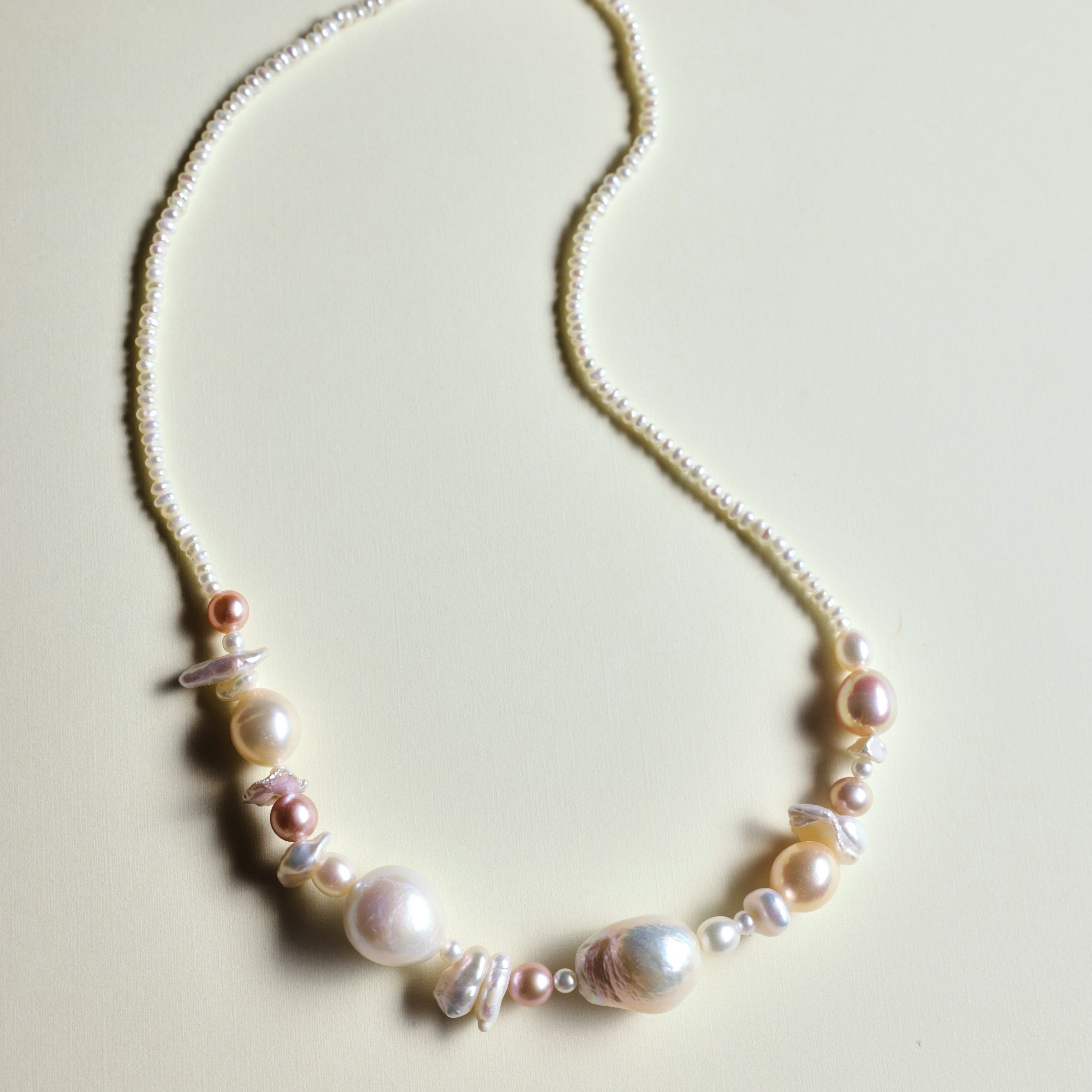 Custom Handmade Freshwater Pearl Necklace - Tailored Just for You!
This beautiful pearl necklace can be customized to match your favorite color palette! Featuring a stunning mix of pink-hued freshwater pearls—Baroque pearls, Keshi pearls, round pearls, and tiny seed pearls—this necklace is a one-of-a-kind piece. Each strand is handmade with love and care, ensuring that your necklace is truly special and as unique as you are.
The Meaning Behind Pink Pearls & Baroque Pearls