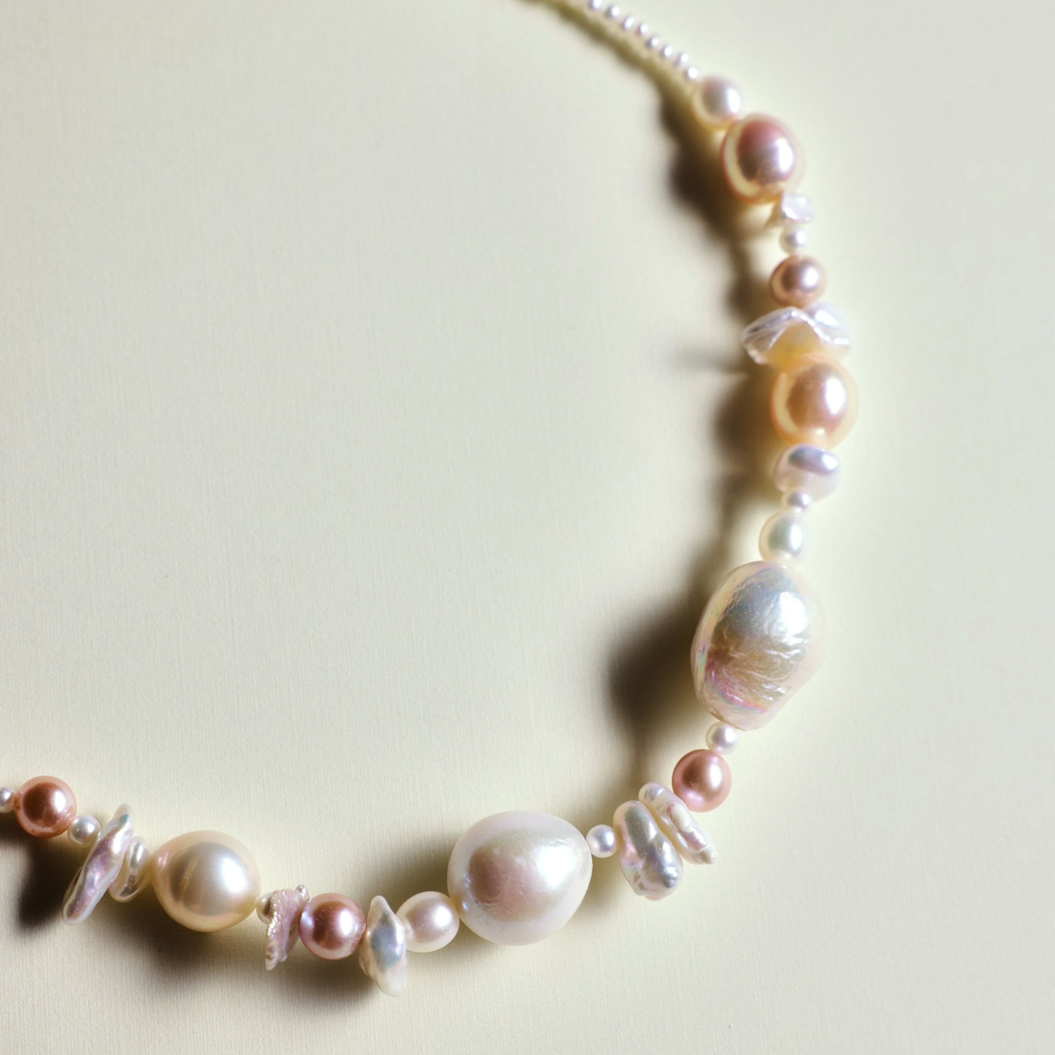 The seaside treasure pearl necklace can be customized to match your favorite color palette! Featuring a stunning mix of pink-hued freshwater pearls—Baroque pearls, Keshi pearls, round pearls, and tiny seed pearls—this necklace is a one-of-a-kind piece. Each strand is handmade with love and care, ensuring that your necklace is truly special and as unique as you are.

The Meaning Behind Pink Pearls & Baroque Pearls