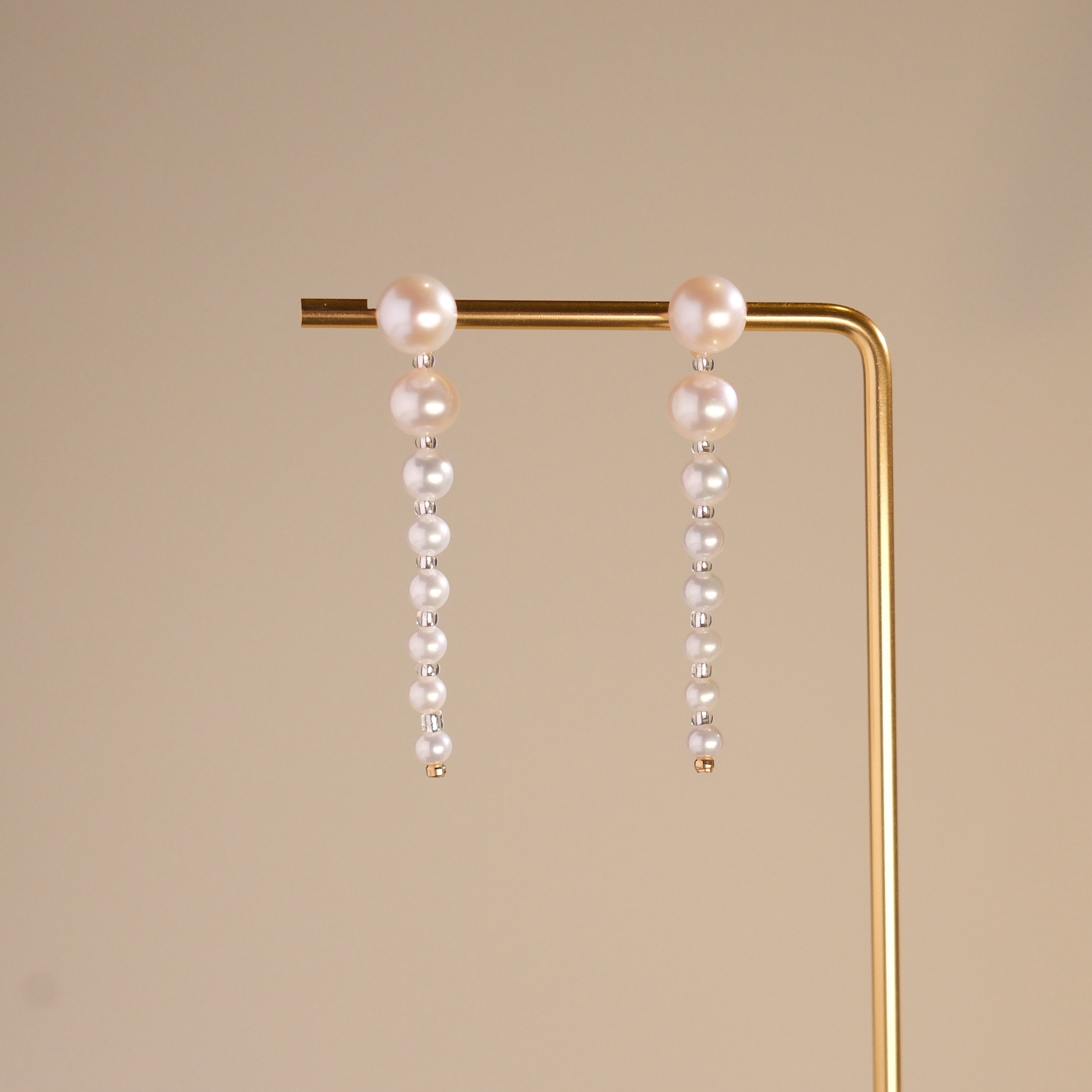 These elegant earrings are made with eight beautifully round and smooth Freshwater Akoya pearls, arranged from largest to smallest. The lustrous pearls will add a delicate and sophisticated touch to your outfit, whether it’s for a casual day or a special evening event. Each pearl’s natural beauty is sure to catch the light and enhance your look.
Materials & Craftsmanship: We use only the finest Freshwater Akoya pearls, carefully selected for their luster and quality. Each pair of earrings is handmade with a