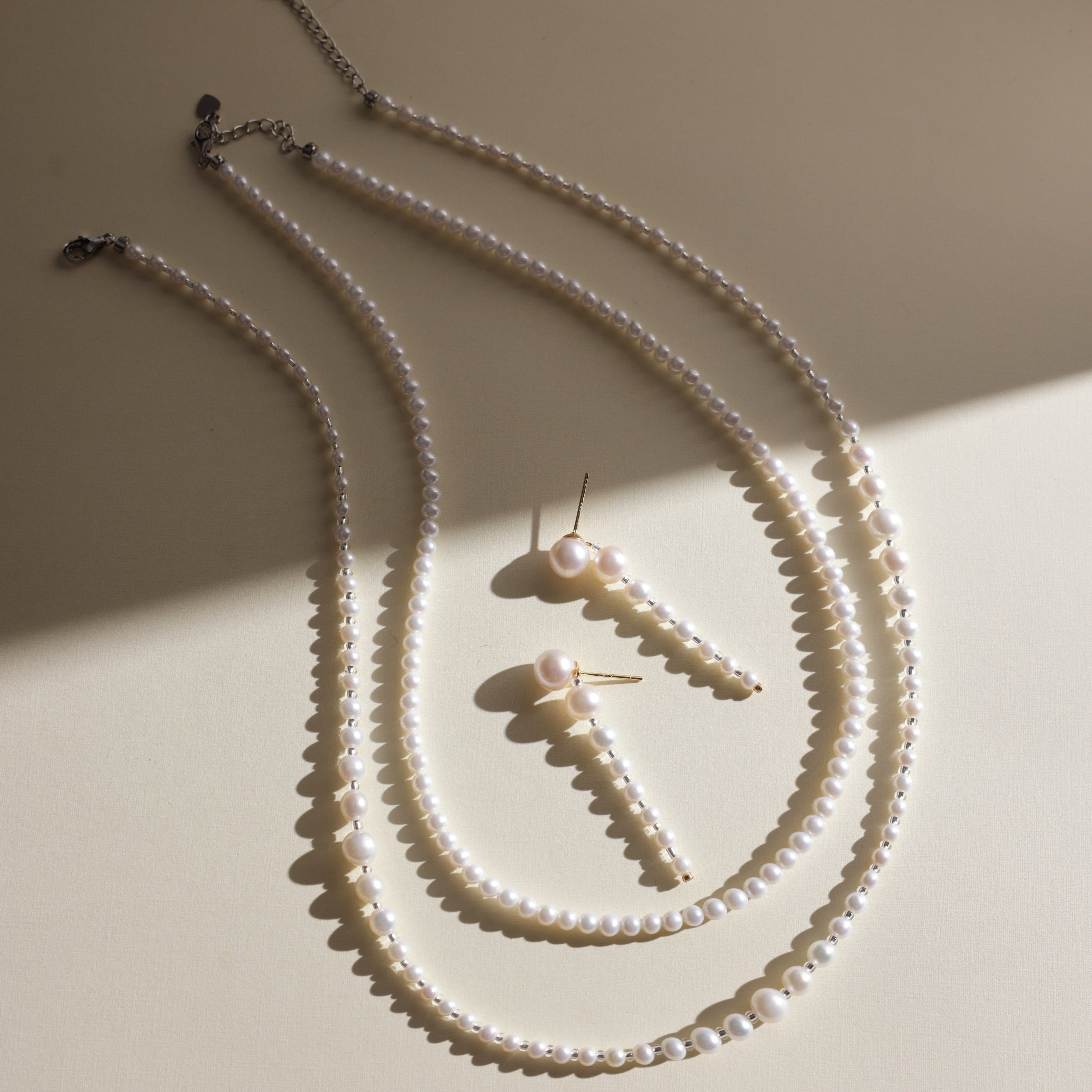 Product Description: This beautiful set of two freshwater pearl necklaces is designed to be worn together or separately for an effortlessly chic layered look. The necklaces feature smooth, round pearls with a radiant luster that will add sophistication to any outfit. Whether you’re dressing up for an event or adding a touch of elegance to your everyday style, these pearl necklaces are perfect for enhancing your wardrobe.
Materials & Craftsmanship: Handcrafted with the finest natural freshwater pearls, each 