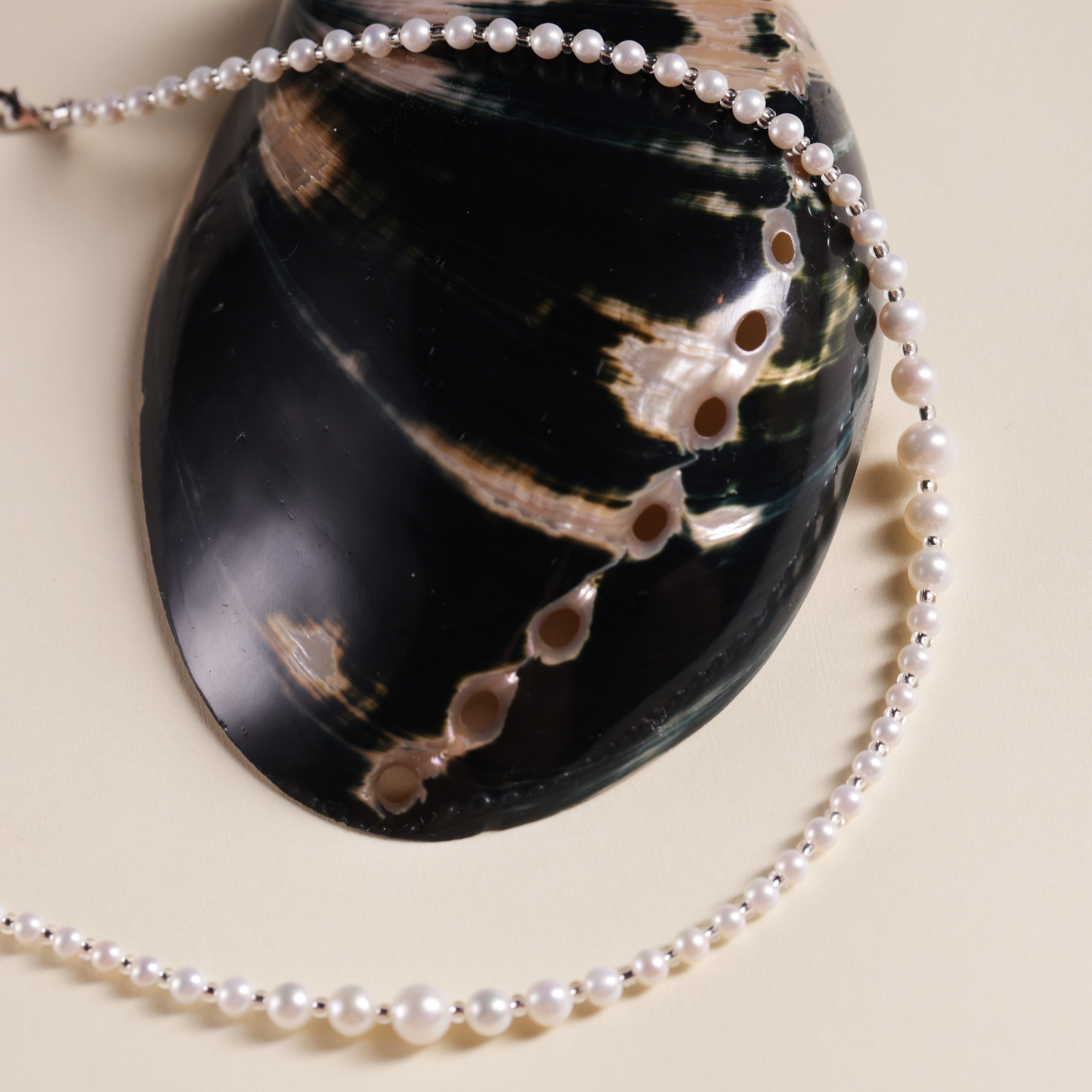 Product Description: This beautiful set of two freshwater pearl necklaces is designed to be worn together or separately for an effortlessly chic layered look. The necklaces feature smooth, round pearls with a radiant luster that will add sophistication to any outfit. Whether you’re dressing up for an event or adding a touch of elegance to your everyday style, these pearl necklaces are perfect for enhancing your wardrobe.
Materials & Craftsmanship: Handcrafted with the finest natural freshwater pearls, each 