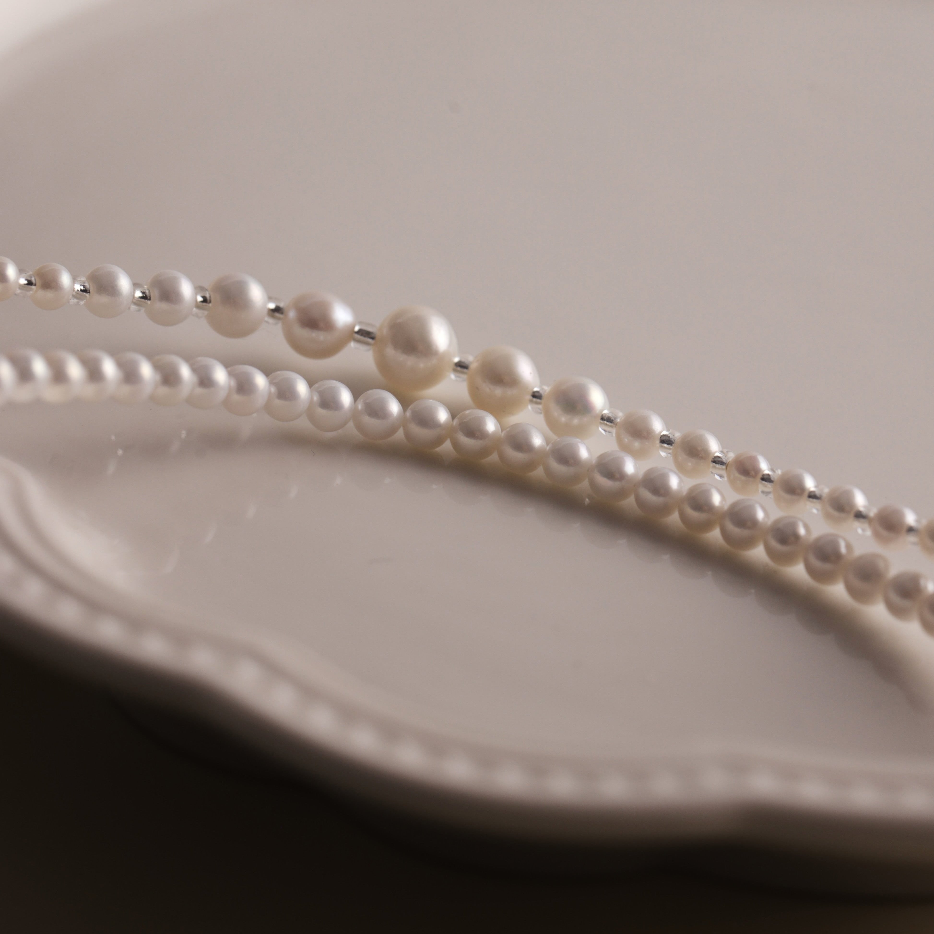 Product Description: This beautiful set of two freshwater pearl necklaces is designed to be worn together or separately for an effortlessly chic layered look. The necklaces feature smooth, round pearls with a radiant luster that will add sophistication to any outfit. Whether you’re dressing up for an event or adding a touch of elegance to your everyday style, these pearl necklaces are perfect for enhancing your wardrobe.
Materials & Craftsmanship: Handcrafted with the finest natural freshwater pearls, each 
