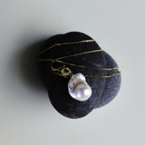 This beautiful necklace features a stunning Baroque freshwater pearl pendant with an exceptional luster. The pendant is removable, allowing you to mix and match it with other necklaces from your collection. The chain is gold-filled, offering lasting color and shine, making this a versatile and timeless addition to your jewelry box.
The Meaning of Baroque Pearls: Baroque pearls, with their unique and irregular shapes, symbolize individuality and natural beauty. Each pearl is one-of-a-kind, representing the u