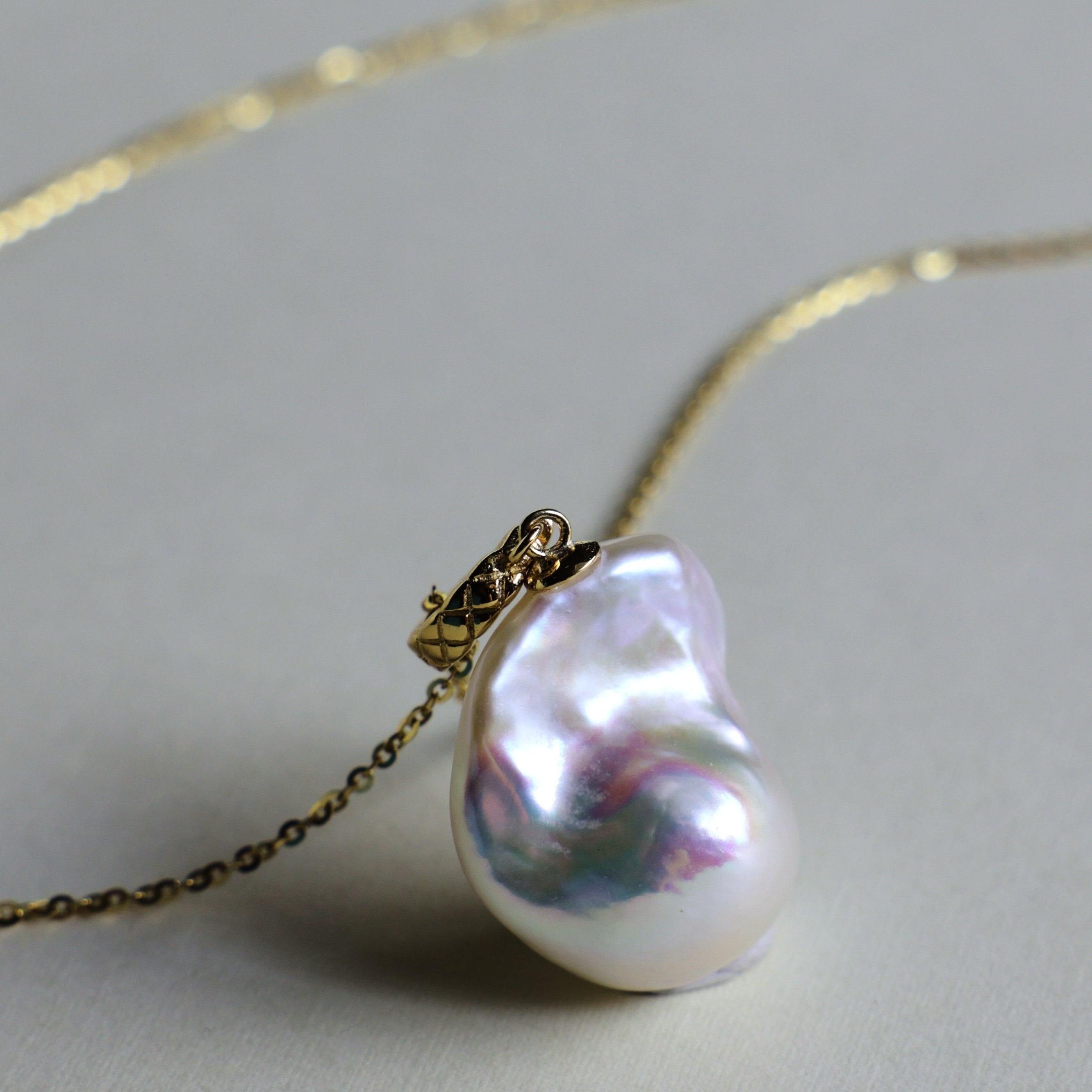 This beautiful necklace features a stunning Baroque freshwater pearl pendant with an exceptional luster. The pendant is removable, allowing you to mix and match it with other necklaces from your collection. The chain is gold-filled, offering lasting color and shine, making this a versatile and timeless addition to your jewelry box.
The Meaning of Baroque Pearls: Baroque pearls, with their unique and irregular shapes, symbolize individuality and natural beauty. Each pearl is one-of-a-kind, representing the u