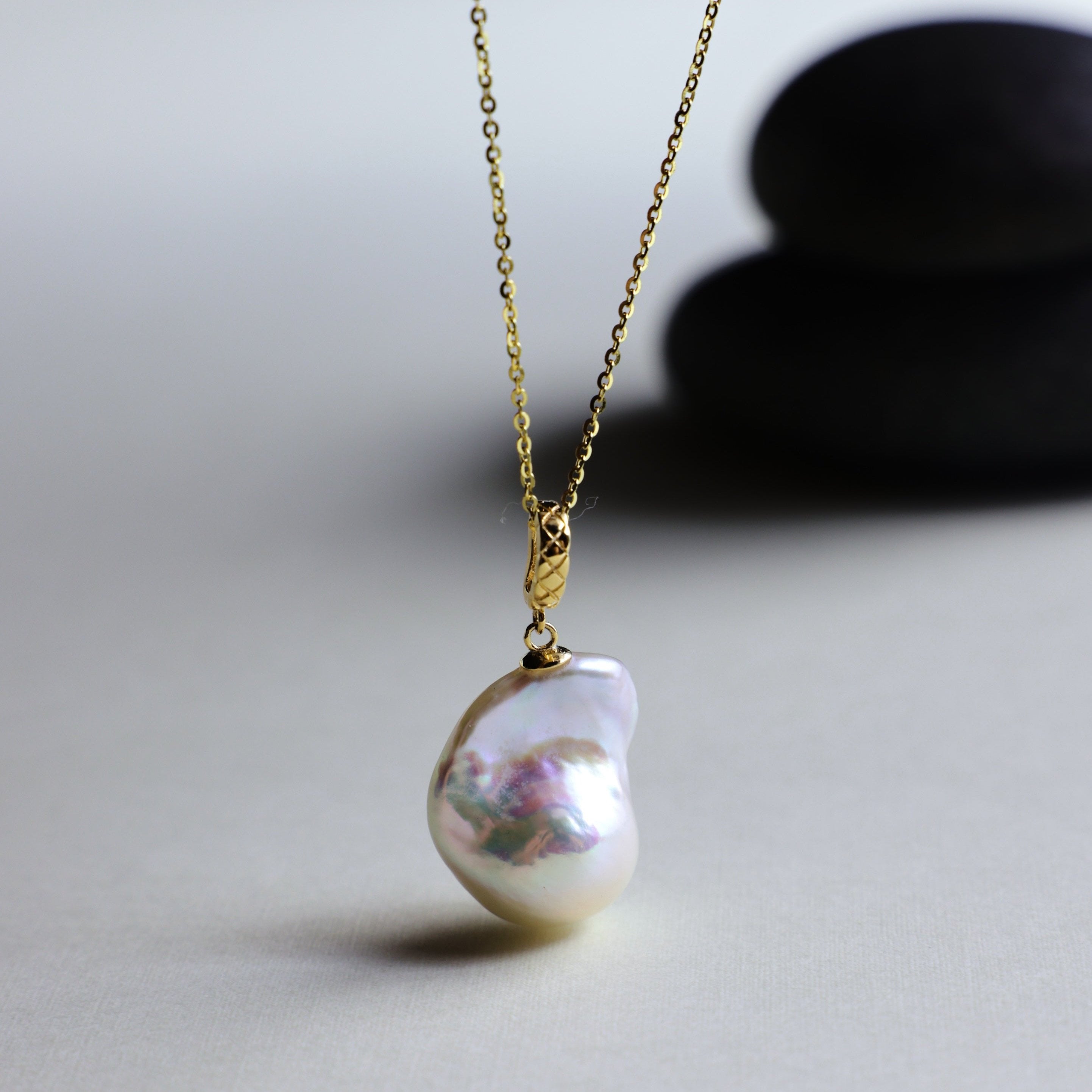 This beautiful necklace features a stunning Baroque freshwater pearl pendant with an exceptional luster. The pendant is removable, allowing you to mix and match it with other necklaces from your collection. The chain is gold-filled, offering lasting color and shine, making this a versatile and timeless addition to your jewelry box.
The Meaning of Baroque Pearls: Baroque pearls, with their unique and irregular shapes, symbolize individuality and natural beauty. Each pearl is one-of-a-kind, representing the u