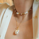 This beautiful necklace features a stunning Baroque freshwater pearl pendant with an exceptional luster. The pendant is removable, allowing you to mix and match it with other necklaces from your collection. The chain is gold-filled, offering lasting color and shine, making this a versatile and timeless addition to your jewelry box.
The Meaning of Baroque Pearls: Baroque pearls, with their unique and irregular shapes, symbolize individuality and natural beauty. Each pearl is one-of-a-kind, representing the u