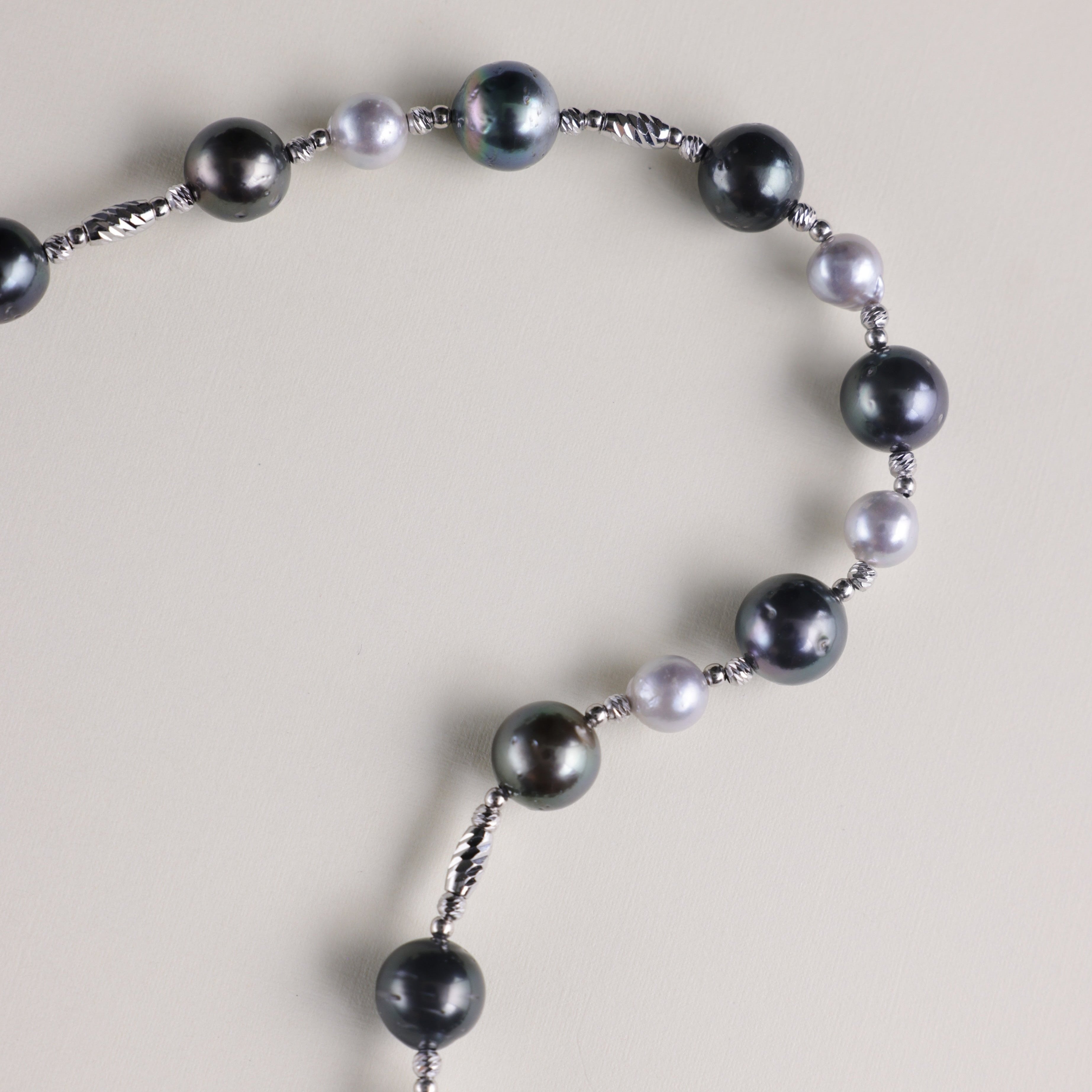 This striking necklace features a luxurious combination of rich Tahitian black pearls and radiant blue Akoya pearls, delicately spaced to create an elegant contrast. The deep, dark hues of the black pearls pair beautifully with the soft, iridescent glow of the blue Akoya pearls, making this necklace a standout piece. Whether worn for a special occasion or to elevate your everyday style, this necklace brings a touch of the exotic to any outfit. Tahitian black pearls are symbols of mystery, independence, and 