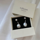 These earrings feature a detachable design that allows you to wear the round pearl with zircon accents for a minimalist look, or add the Keshi pearl for a more dramatic effect. The unique combination of differently shaped pearls with sterling silver and zircon detailing creates a stunning visual contrast, while the versatility of the design makes these earrings a must-have addition to any jewelry collection.
Materials:
- Pearls: One 10mm Keshi pearl and one 6-7mm round pearl on each earring.
- Metal: All co
