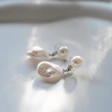 These earrings feature a detachable design that allows you to wear the round pearl with zircon accents for a minimalist look, or add the Keshi pearl for a more dramatic effect. The unique combination of differently shaped pearls with sterling silver and zircon detailing creates a stunning visual contrast, while the versatility of the design makes these earrings a must-have addition to any jewelry collection.
Materials:
- Pearls: One 10mm Keshi pearl and one 6-7mm round pearl on each earring.
- Metal: All co