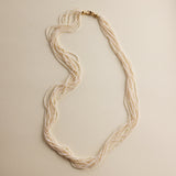 This extraordinary necklace is crafted from thousands of the world's smallest Akoya saltwater pearls, delicately hand-strung into 10 graceful strands. Each pearl measures just 1.0-1.5mm in size, a true testament to the incredible craftsmanship required to create such a piece. The process of drilling these baby pearls is so precise that nearly 1/3 of the pearls are lost, making this necklace an exceptionally rare and luxurious creation. These pearls are the type you’d expect to see in high couture jewelry, r