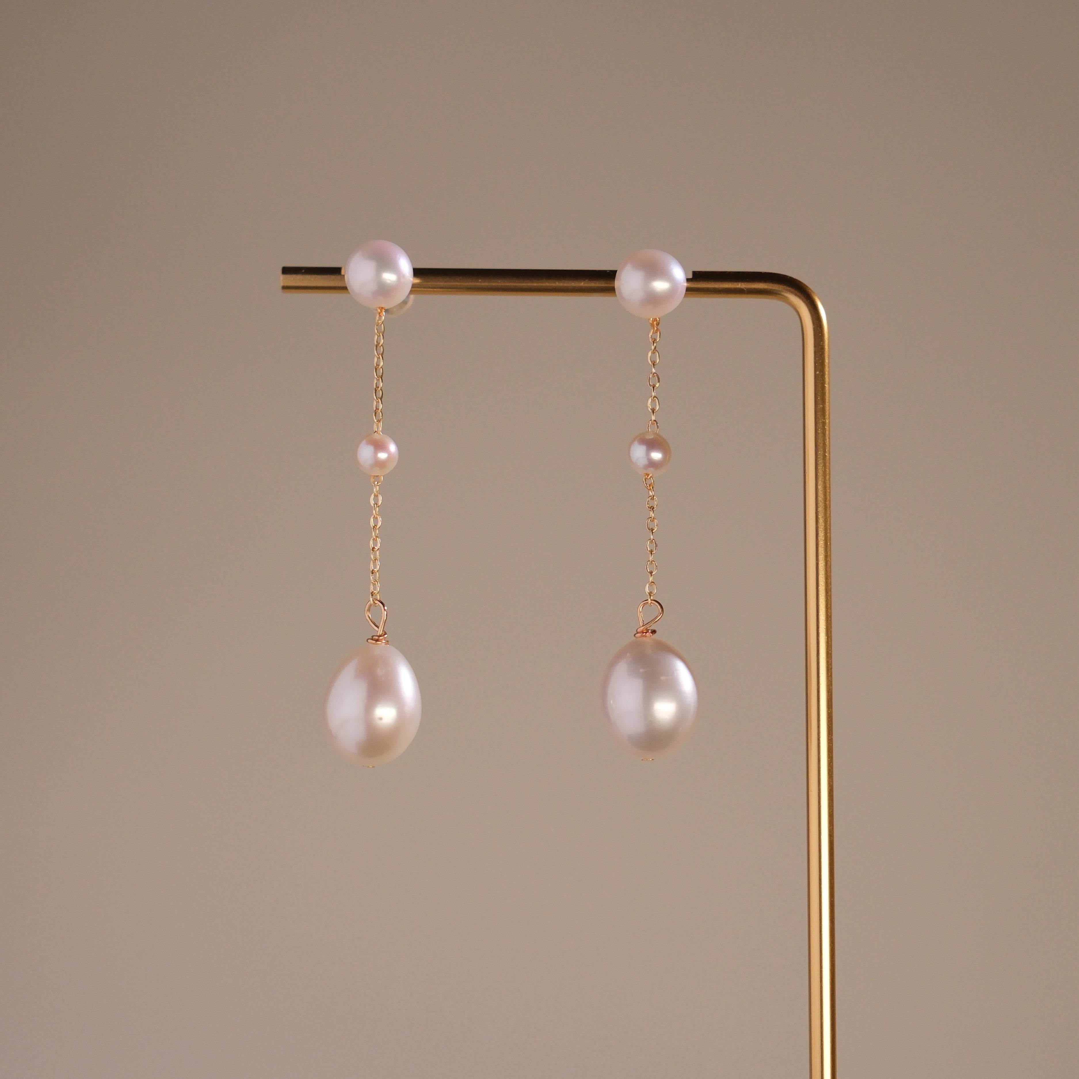 These elegant pearl drop earrings feature a gentle, cascading design of three pearls, meant to reflect the beauty of water droplets splashing into a serene surface. Crafted to add a soft glow to your look, these earrings symbolize vitality and positivity, reminding the wearer to approach life with energy and grace.
Materials & Craftsmanship: Each pair is handcrafted with care using lustrous freshwater pearls and high-quality, durable materials. We ensure every detail is perfected to create a radiant and lon