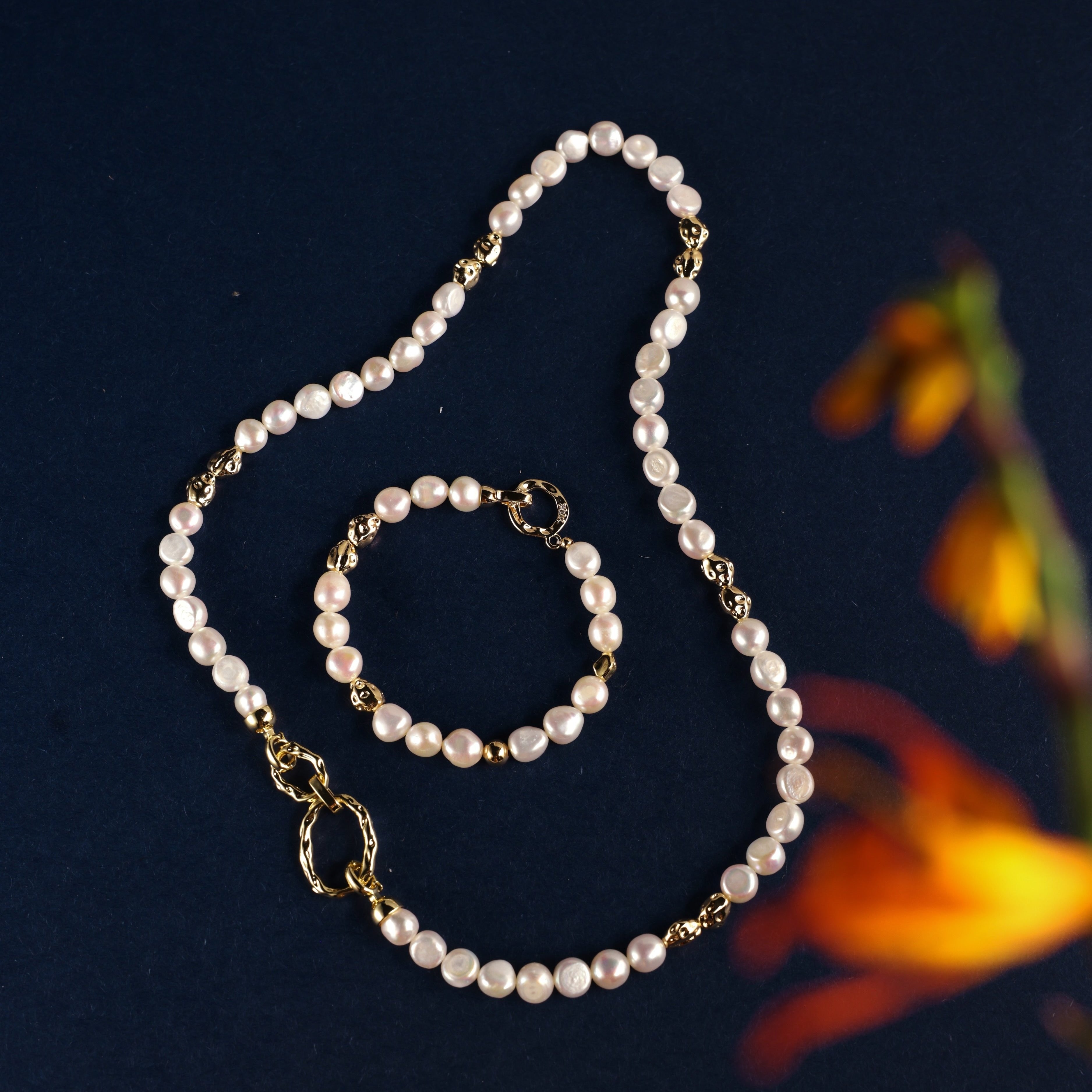 Freshwater Pearl Necklace and Bracelet Set | Versatile and Elegant | 18K Gold Filled | Gift for Her | Fall Outfit 
This set, featuring a smooth and lustrous collection of natural freshwater pearls, offers endless styling possibilities. Wear the necklace and bracelet separately or connect the clasps to create a chic long necklace. This versatile design is not only fun to wear but can be layered with one of our baroque pearl necklaces to create a more luxurious look. Whether worn individually or combined, the