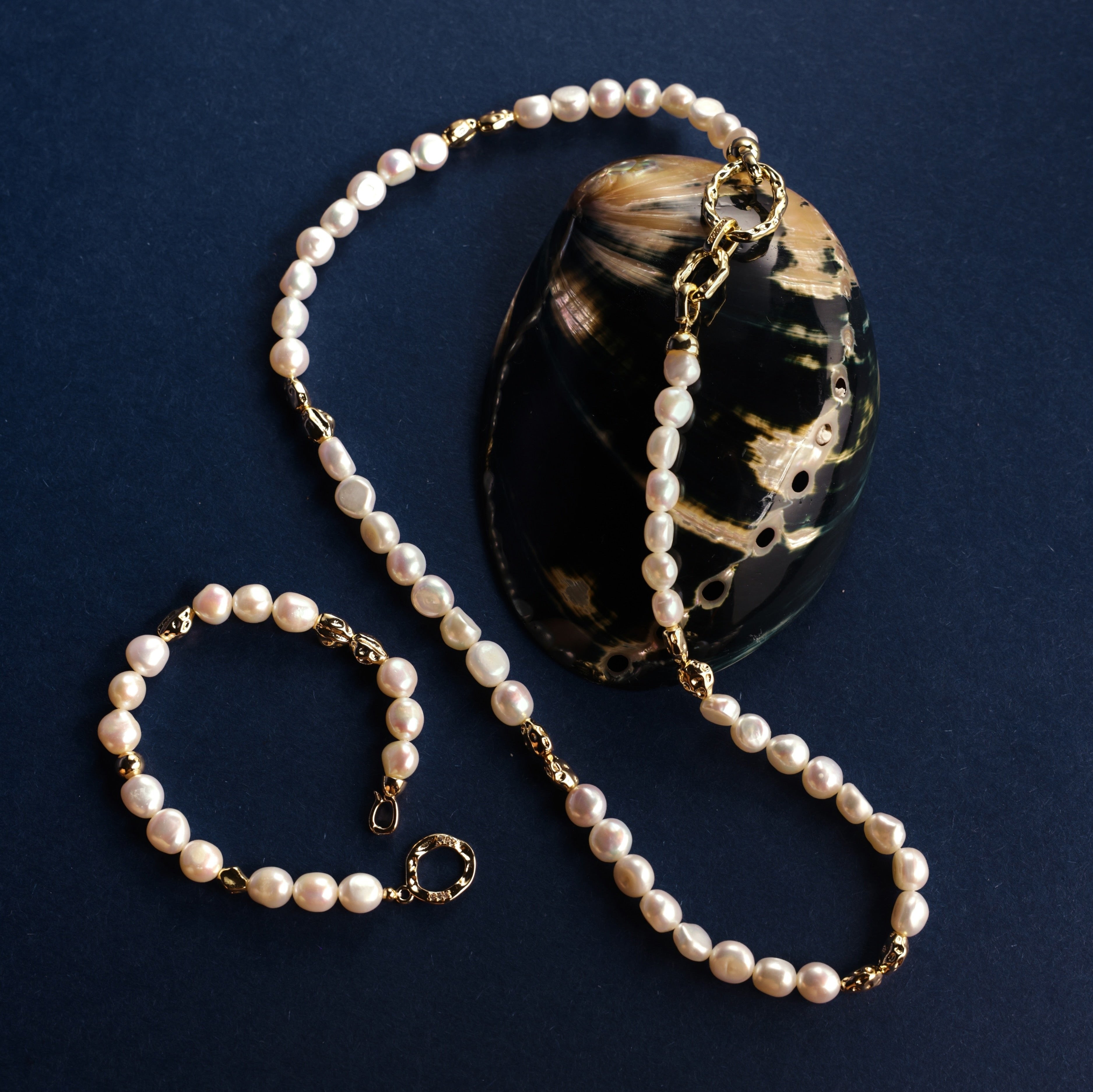 Freshwater Pearl Necklace and Bracelet Set | Versatile and Elegant | 18K Gold Filled | Gift for Her | Fall Outfit 
This set, featuring a smooth and lustrous collection of natural freshwater pearls, offers endless styling possibilities. Wear the necklace and bracelet separately or connect the clasps to create a chic long necklace. This versatile design is not only fun to wear but can be layered with one of our baroque pearl necklaces to create a more luxurious look. Whether worn individually or combined, the