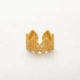 Gold wire-crafted ring on a white background