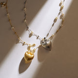 Necklace with heart-shaped pendants on a neutral background
