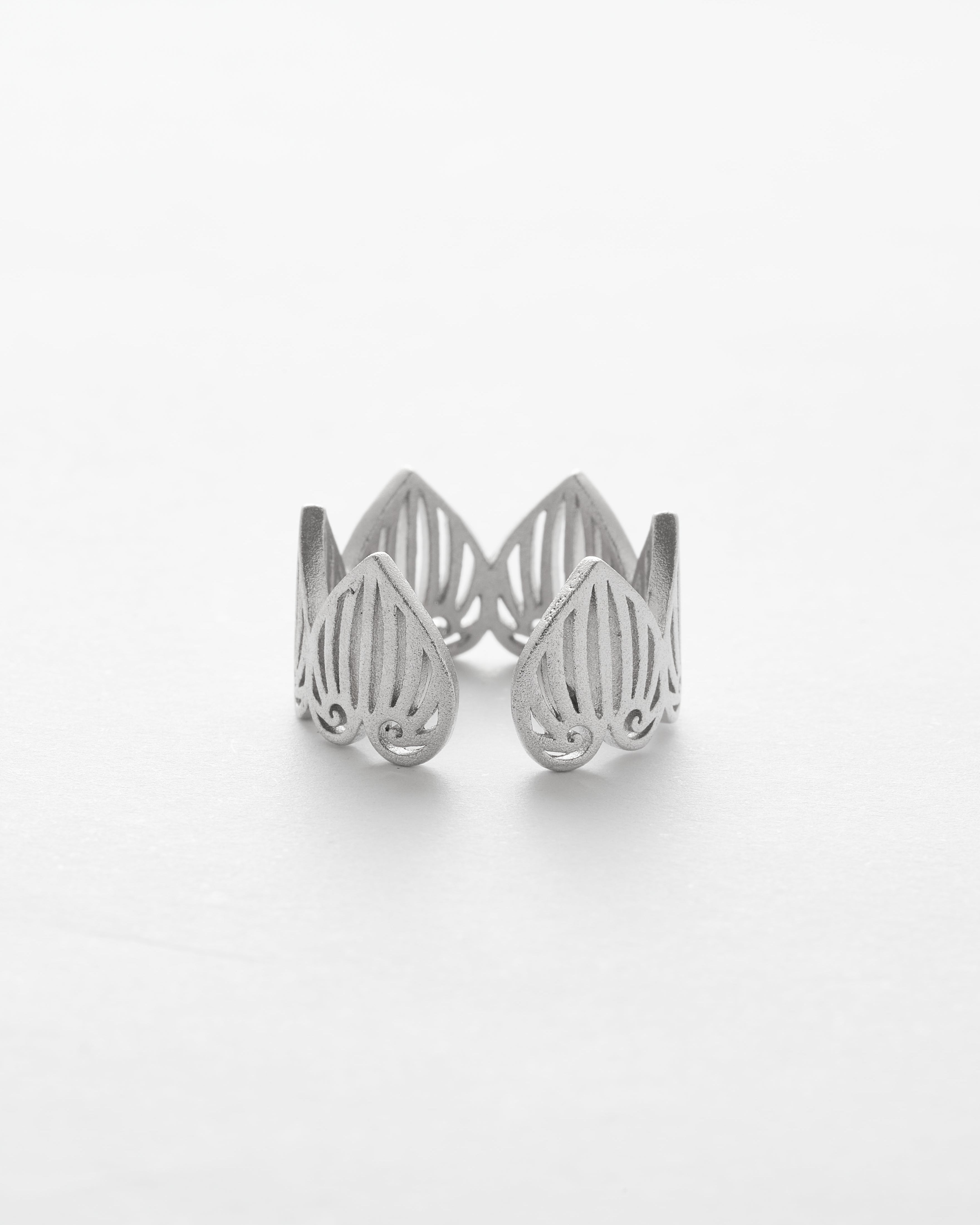 Silver openwork ring on a white background