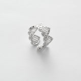 Silver ring with a unique design on a white background