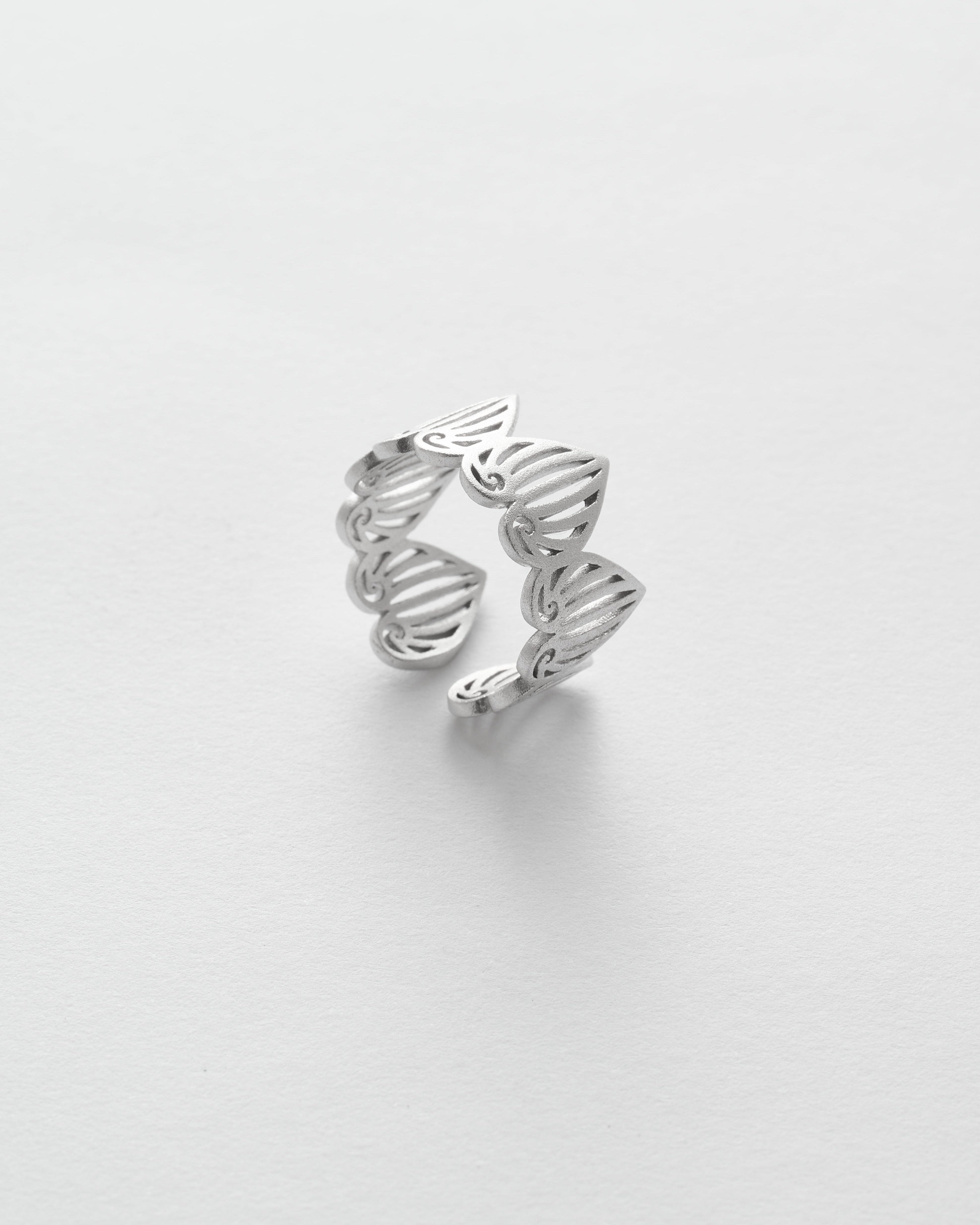 Silver ring with a unique design on a white background