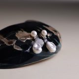 These earrings feature a detachable design that allows you to wear the round pearl with zircon accents for a minimalist look, or add the Keshi pearl for a more dramatic effect. The unique combination of differently shaped pearls with sterling silver and zircon detailing creates a stunning visual contrast, while the versatility of the design makes these earrings a must-have addition to any jewelry collection.
Materials:
- Pearls: One 10mm Keshi pearl and one 6-7mm round pearl on each earring.
- Metal: All co