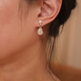 These earrings feature a detachable design that allows you to wear the round pearl with zircon accents for a minimalist look, or add the Keshi pearl for a more dramatic effect. The unique combination of differently shaped pearls with sterling silver and zircon detailing creates a stunning visual contrast, while the versatility of the design makes these earrings a must-have addition to any jewelry collection.
Materials:
- Pearls: One 10mm Keshi pearl and one 6-7mm round pearl on each earring.
- Metal: All co