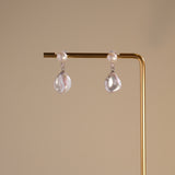 These earrings feature a detachable design that allows you to wear the round pearl with zircon accents for a minimalist look, or add the Keshi pearl for a more dramatic effect. The unique combination of differently shaped pearls with sterling silver and zircon detailing creates a stunning visual contrast, while the versatility of the design makes these earrings a must-have addition to any jewelry collection.
Materials:
- Pearls: One 10mm Keshi pearl and one 6-7mm round pearl on each earring.
- Metal: All co
