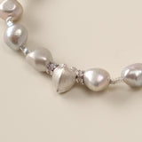 A celestial dance of contrasts, the Meiocardia Vulgaris & Keshi Pearl Bracelet unites the raw magic of ocean-born treasures with the shimmering mystery of the cosmos. Designed for free spirits who embrace imperfection as art, this piece blends a rare heart-shaped shell bead with the organic allure of keshi pearls—a testament to beauty forged in nature’s unpredictable hands.
Design & Craftsmanship:
- Dual-Perspective Heart Charm: The focal 8.0*9.8mm Meiocardia vulgaris bead, cast in hypoallergenic S925 silve