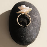 This exquisite floral ring is crafted from rare Keshi petal pearls and topped with a lustrous round freshwater pearl at its center. The natural petal pearls beautifully mimic the delicate petals of a rose, creating a unique and captivating design. The Keshi pearls, known for their irregular shape and stunning luster, make this ring a one-of-a-kind piece that’s perfect for any occasion.Ring is made using high-quality Keshi petal pearls and a freshwater pearl, set on an 18k gold-filled adjustable band