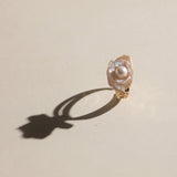 This exquisite floral ring is crafted from rare Keshi petal pearls and topped with a lustrous round freshwater pearl at its center. The natural petal pearls beautifully mimic the delicate petals of a rose, creating a unique and captivating design. The Keshi pearls, known for their irregular shape and stunning luster, make this ring a one-of-a-kind piece that’s perfect for any occasion.Ring is made using high-quality Keshi petal pearls and a freshwater pearl, set on an 18k gold-filled adjustable band