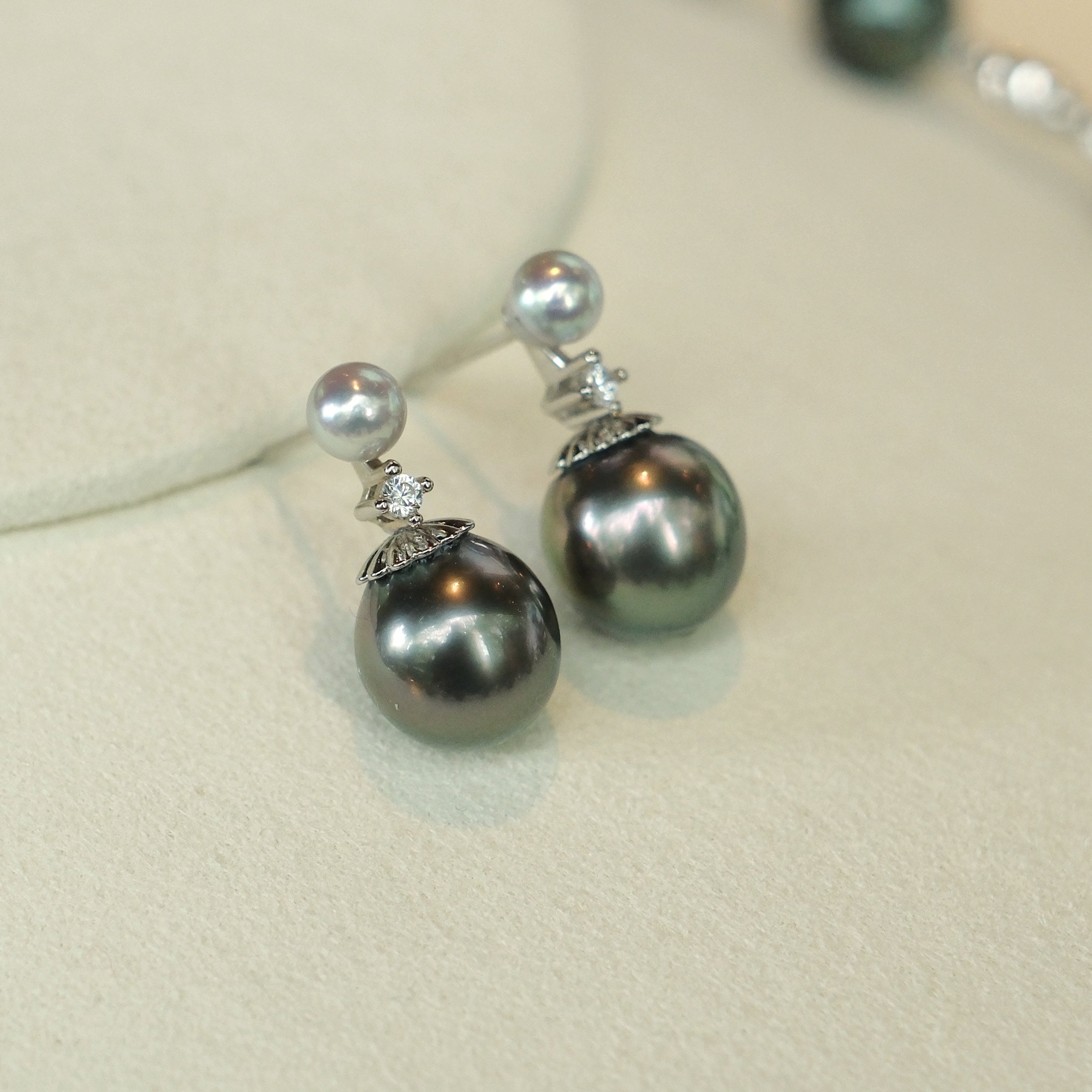 Just like the matching necklace, these earrings were inspired by my mom’s love for Tahitian pearls. She always adored their elegance but wanted a design that could be worn every day, not just for special occasions. To create a more versatile and youthful look, I paired these rich Tahitian black pearls with shimmering blue Akoya pearls and a touch of sparkle with a diamond accent. 
Materials:
- Tahitian black pearls
- Blue Akoya pearls
- Sparkling cubic zirconia (man-made diamond)
- Silver accents
- All hand
