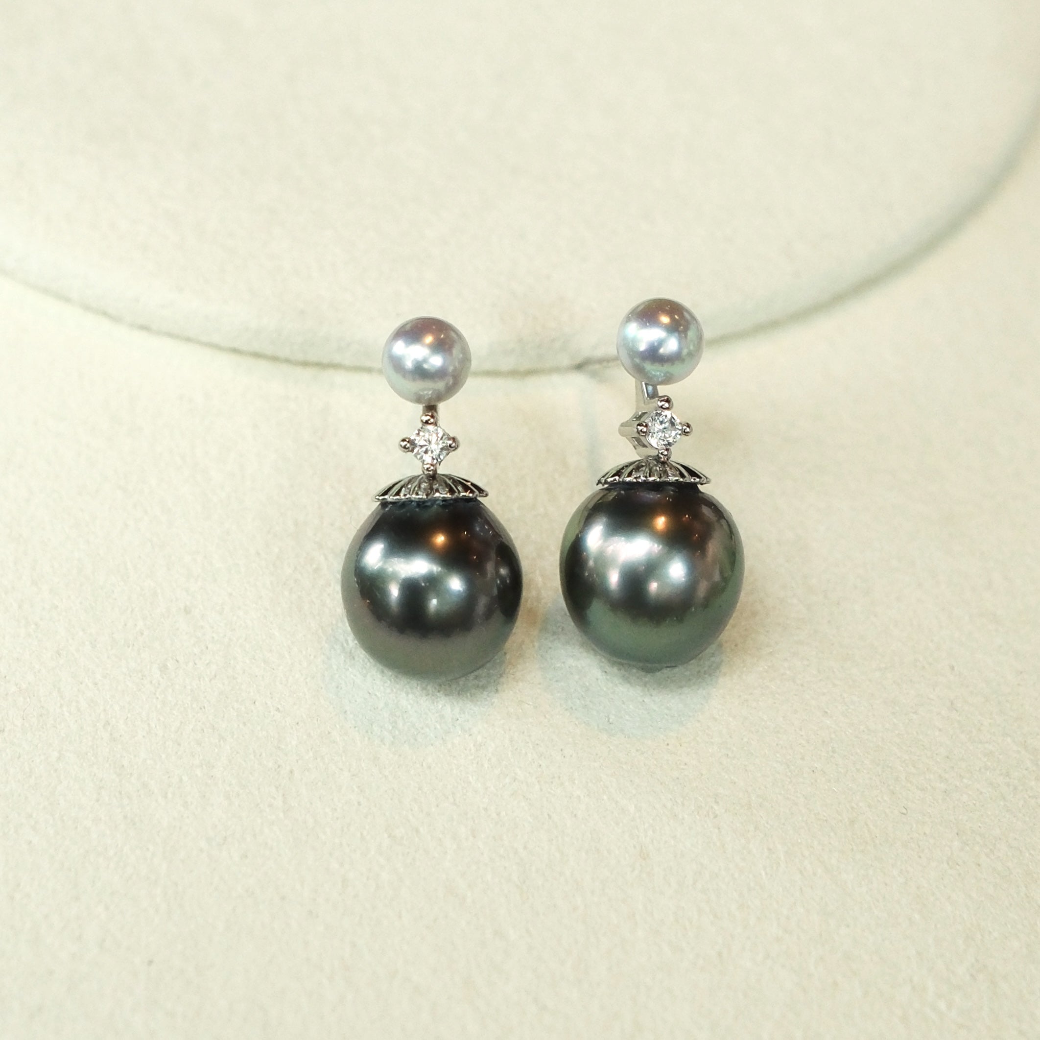 Just like the matching necklace, these earrings were inspired by my mom’s love for Tahitian pearls. She always adored their elegance but wanted a design that could be worn every day, not just for special occasions. To create a more versatile and youthful look, I paired these rich Tahitian black pearls with shimmering blue Akoya pearls and a touch of sparkle with a diamond accent. 
Materials:
- Tahitian black pearls
- Blue Akoya pearls
- Sparkling cubic zirconia (man-made diamond)
- Silver accents
- All hand