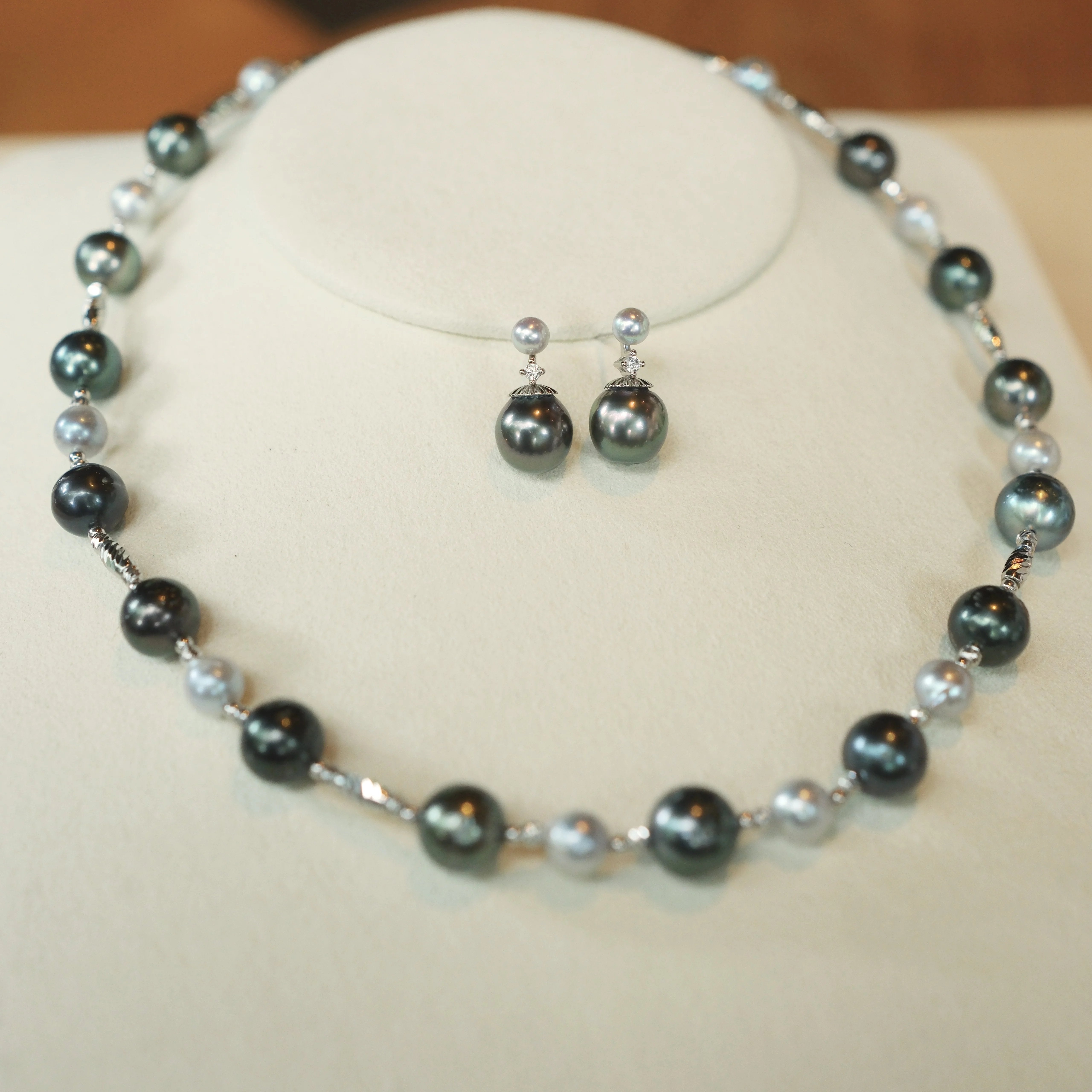 Just like the matching necklace, these earrings were inspired by my mom’s love for Tahitian pearls. She always adored their elegance but wanted a design that could be worn every day, not just for special occasions. To create a more versatile and youthful look, I paired these rich Tahitian black pearls with shimmering blue Akoya pearls and a touch of sparkle with a diamond accent. 
Materials:
- Tahitian black pearls
- Blue Akoya pearls
- Sparkling cubic zirconia (man-made diamond)
- Silver accents
- All hand