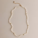 Gold and pearls—an unbeatable combination that always exudes style. This delicate pearl necklace is part of a matching set with a pearl bracelet, designed to add a chic finishing touch to your look. You can also layer it with our baroque pearl necklace for a more luxurious and bold style. Check out the listing photos for styling ideas!
- Necklace Length: 
- Extension Chain: 

Styling Tips:
This necklace is perfect for layering, whether with its matching bracelet or other pearl pieces in our collection. Pair