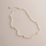 Gold and pearls—an unbeatable combination that always exudes style. This delicate pearl necklace is part of a matching set with a pearl bracelet, designed to add a chic finishing touch to your look. You can also layer it with our baroque pearl necklace for a more luxurious and bold style. Check out the listing photos for styling ideas!
- Necklace Length: 
- Extension Chain: 

Styling Tips:
This necklace is perfect for layering, whether with its matching bracelet or other pearl pieces in our collection. Pair