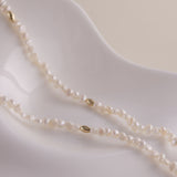 Gold and pearls—an unbeatable combination that always exudes style. This delicate pearl necklace is part of a matching set with a pearl bracelet, designed to add a chic finishing touch to your look. You can also layer it with our baroque pearl necklace for a more luxurious and bold style. Check out the listing photos for styling ideas!
- Necklace Length: 
- Extension Chain: 

Styling Tips:
This necklace is perfect for layering, whether with its matching bracelet or other pearl pieces in our collection. Pair