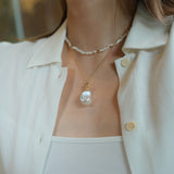 Gold and pearls—an unbeatable combination that always exudes style. This delicate pearl necklace is part of a matching set with a pearl bracelet, designed to add a chic finishing touch to your look. You can also layer it with our baroque pearl necklace for a more luxurious and bold style. Check out the listing photos for styling ideas!
- Necklace Length: 
- Extension Chain: 

Styling Tips:
This necklace is perfect for layering, whether with its matching bracelet or other pearl pieces in our collection. Pair
