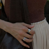 Person with celestes jewelry in heartline rings